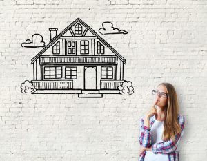 Attractive caucasian girl on brick background with house sketch. Real estate, mortgage and housing concept