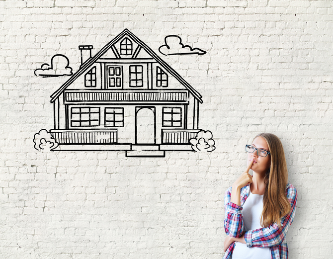 Attractive caucasian girl on brick background with house sketch. Real estate, mortgage and housing concept